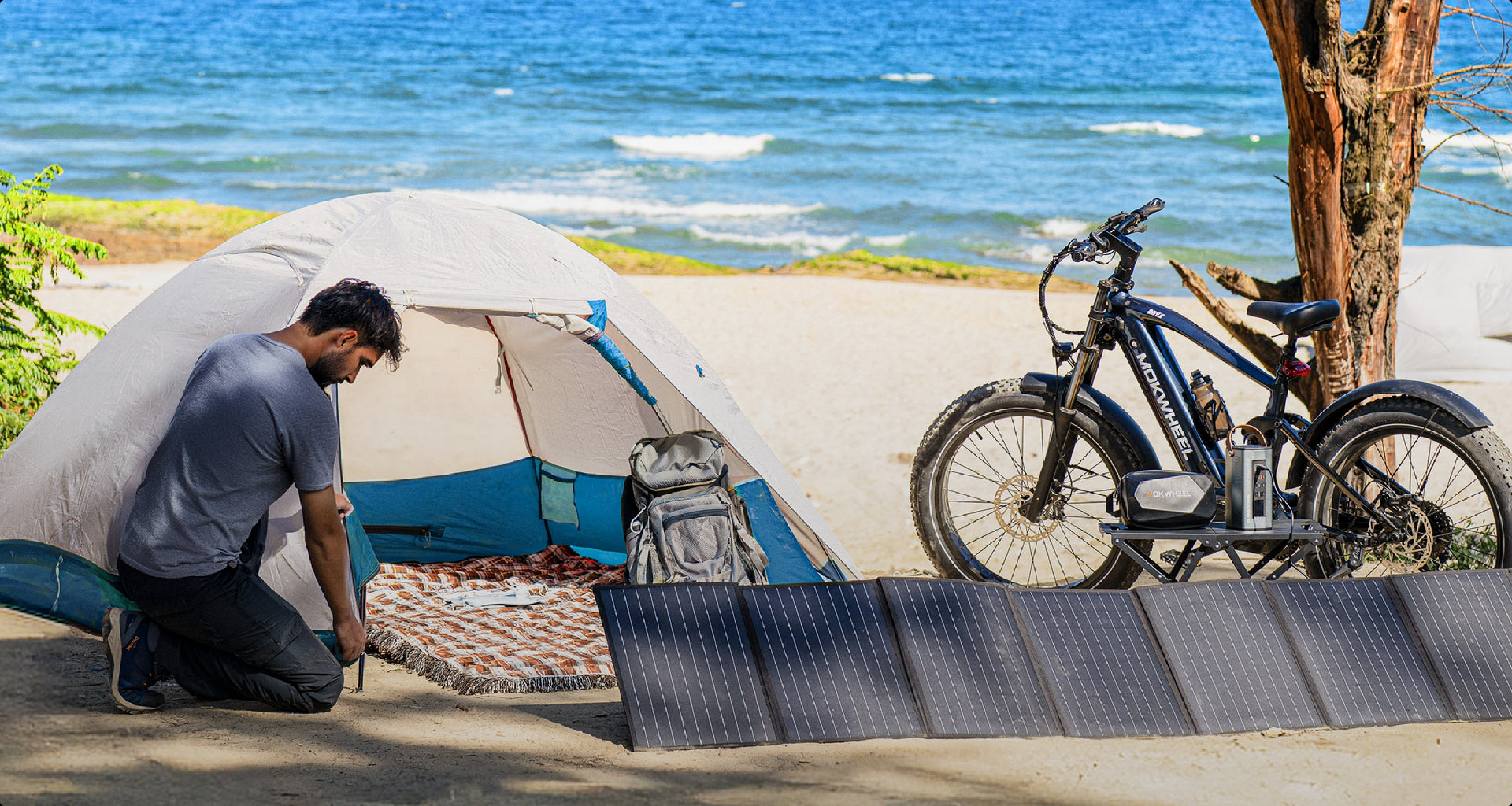 Solar panel kit with inverter powering devices for camping and picnics on a coastal beach