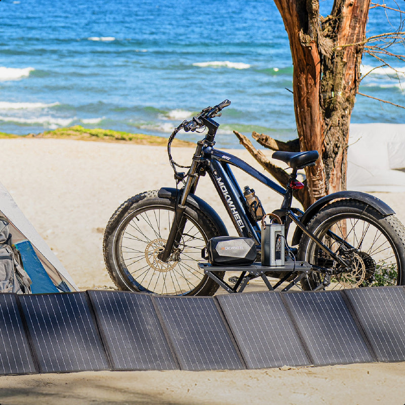 Solar panel kit with inverter powering devices for camping and picnics on a coastal beach