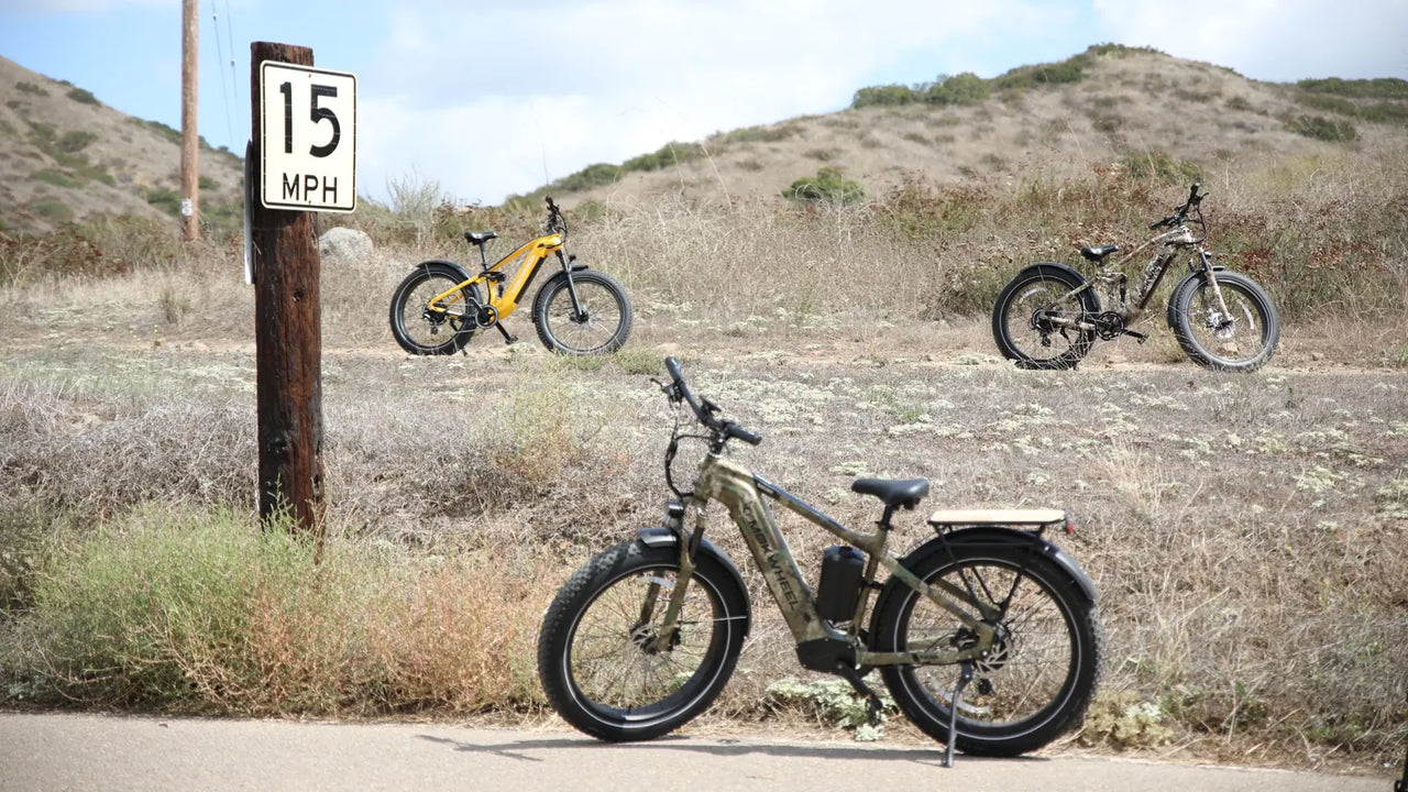 Electric bikes beside a 15 mph trail sign