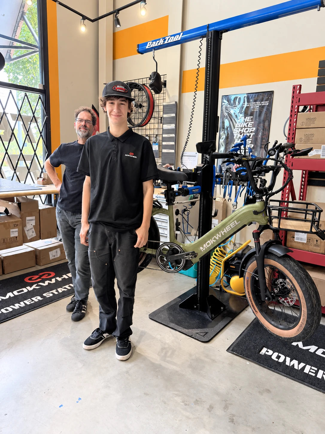 Landon and Brent beside the store’s e-bike repair bench.